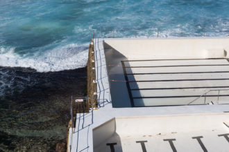 Ben Buckler, blue sky, Bondi, Bondi Baths, Bondi Beach, Bondi Icebergs, Bondi Icebergs Club, corporate decor, Eastern suburbs, Empty Icebergs, Empty Pool, healthcare decor, Historic Landmark, Iceberg, Icebergs Pool Cleaning, Iconic Sydney Location, Lap Pool, Most Famous Beach, ocean, Ocean Pool, Outdoor Swimming Pool, Rip Currents, scenic, Seascape < Sydney, surf, Swimming Club, Swimming Pool Lanes, Sydney Lifestyle, Sydney NSW, Tourist Destination, Tourist Location, Tourists, Travel Destinations, Vertical Lines, view, water, White Empty Icebergs, Winter Swimming Club, World-Famous Beach