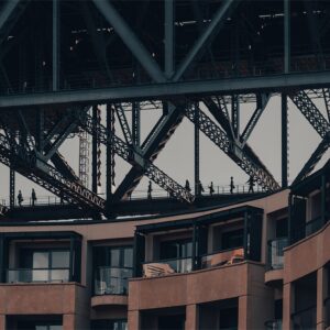 Wall art print featuring bridge climbers at the Sydney Harbour Bridge with the Park Hyatt hotel in the background, captured in a cropped, dynamic composition