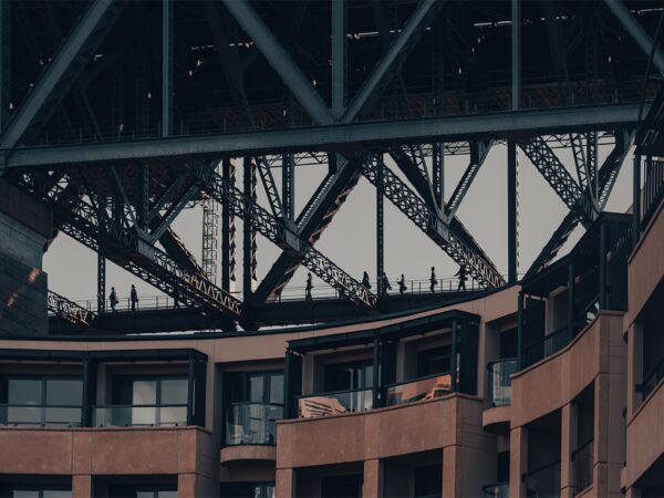 Wall art print featuring bridge climbers at the Sydney Harbour Bridge with the Park Hyatt hotel in the background, captured in a cropped, dynamic composition