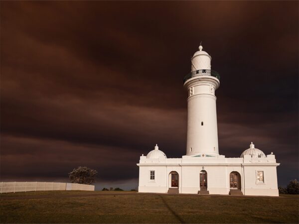 Macquarie Lighthouse surrounded by bushfire smoke, creating dark orange cloud coverage over the lighthouse, Vaucluse, Sydney.