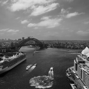 Black and white photograph of the iconic Sydney Harbour skyline, featuring the Sydney Opera House and Harbour Bridge against a timeless backdrop. Perfect as wall decor, this art print captures the city's architectural beauty and urban landscape in a classic monochrome style.