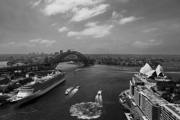 Black and white photograph of the iconic Sydney Harbour skyline, featuring the Sydney Opera House and Harbour Bridge against a timeless backdrop. Perfect as wall decor, this art print captures the city's architectural beauty and urban landscape in a classic monochrome style.