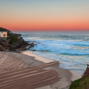 Coastal wall art print of Tamarama Beach with a vibrant orange glow capturing the serene beauty of the Sydney shoreline.