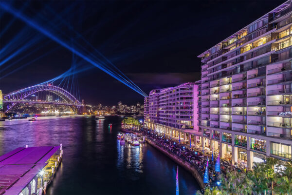 Acrylic print of Bennelong Apartments with a vivid purple glow, part of the Vivid Sydney collection, ideal for elegant home and office decor.