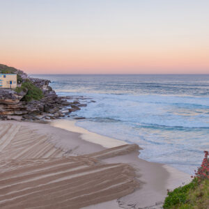 Tamarama Beach sunset wall art print capturing the warm orange glow over Sydney’s coastline, photographed by a professional photographer.