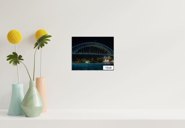 Wall art print of Sydney Harbour Bridge illuminated with vivid lights at night