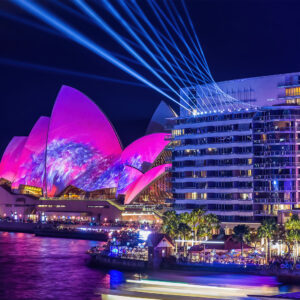 Vivid Sydney fine art print featuring the Sydney Opera House illuminated with pink lights and laser projections, viewed from Bennelong Apartments.