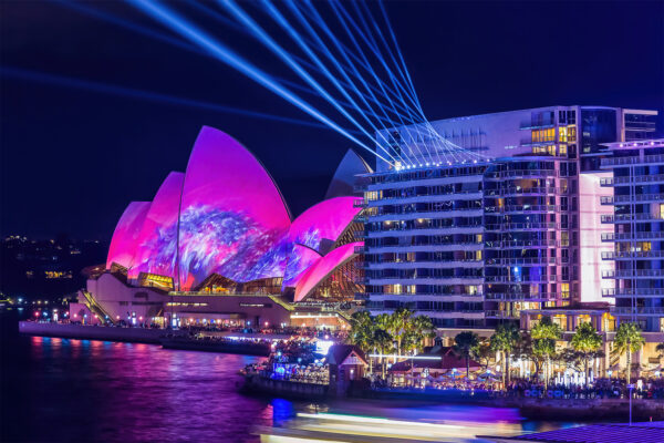 Vivid Sydney fine art print featuring the Sydney Opera House illuminated with pink lights and laser projections, viewed from Bennelong Apartments.