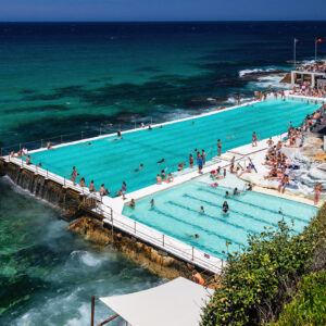 Bondi Icebergs Pool on a sunny summer day with turquoise water, calm ocean waves, and beachgoers enjoying the iconic Sydney location.