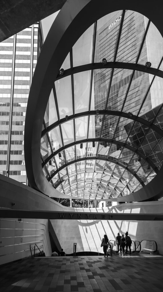 Entrance to the Wynyard Walk canopy with its striking glass roof architecture in Sydney.
