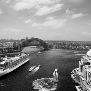 Black and white photograph of Sydney Harbour taken from the rooftop of the historic AMP Building during Open Sydney, showing the Sydney Opera House, The Bennelong Apartments, the Harbour Bridge, a cruise ship near The Rocks, and ferries crossing the water in a timeless, balanced composition.